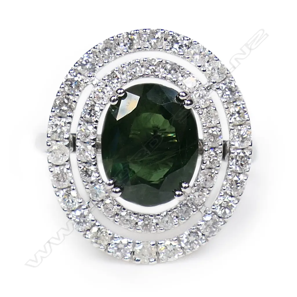 A 14ct white gold green sapphire and diamond double halo ring, Image 1++