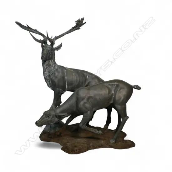 A very large bronze sculpture of a stag and hind,