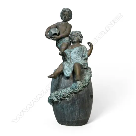 A very large bronze figure group of two children upon a wine barrel,