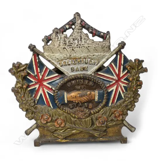 An early 20thC cast iron 'Dreadnought' still money bank,