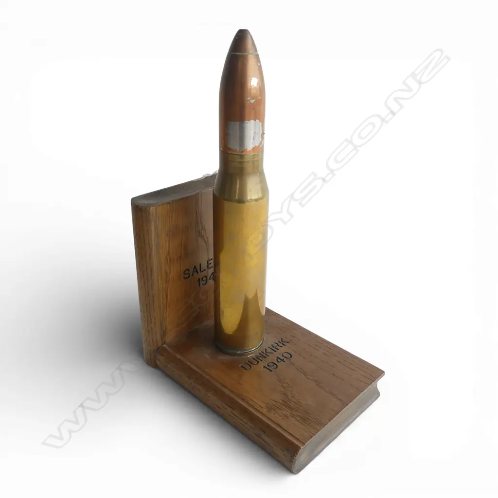 A pair of trench art bookends a shell case set to oak books marked with various WWII battles. H.270mm. Image 1++