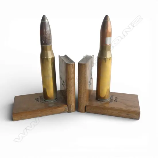 A pair of trench art bookends a shell case set to oak books marked with various WWII battles. H.270mm.