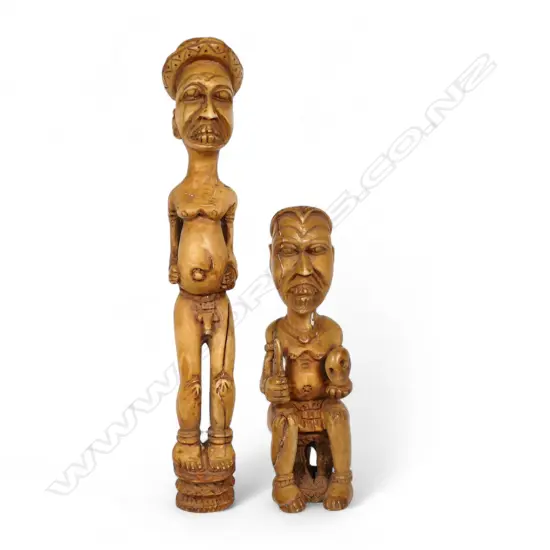 A pair of early 20thC Nigerian carved ivory figures,