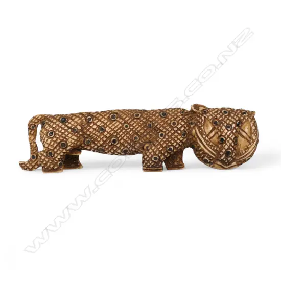 An early 20thC Nigerian carved ivory leopard,