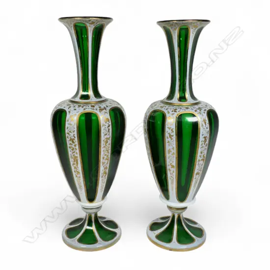 A pair of late 19thC Bohemian white over green glass vases,