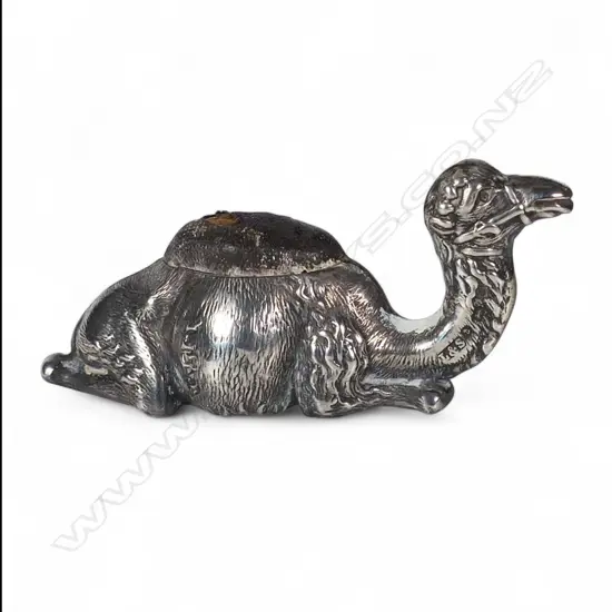 An Edwardian silver recumbent camel pin cushion,