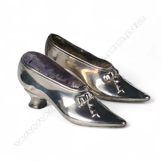 Two Edwardian silver shoe pin cushions,