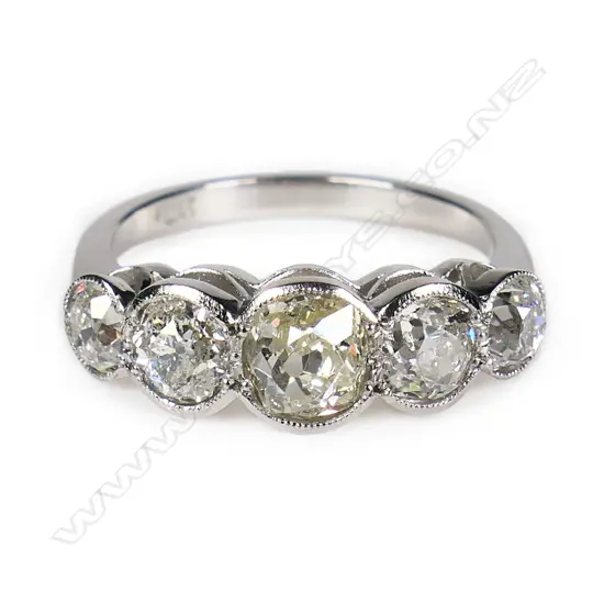 A classic platinum and five diamond ring,
