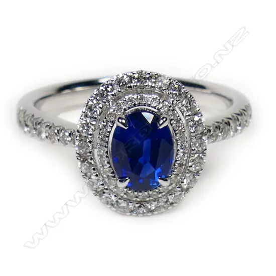 An 18ct white gold sapphire and diamond double halo ring,