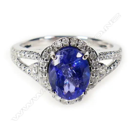 A 14ct white gold tanzanite and diamond halo ring,