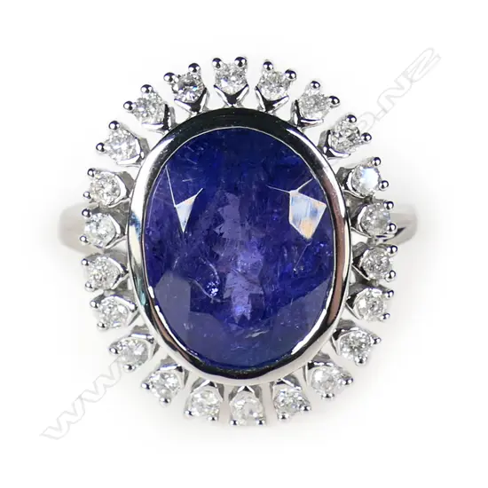 A 14ct white gold tanzanite and diamond halo ring,