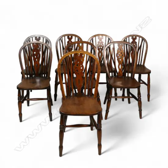 A set of eight Victorian oak and elm country wheel back Windsor chairs,
