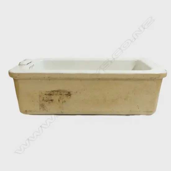 A vintage stone glazed white enamel laundry sink