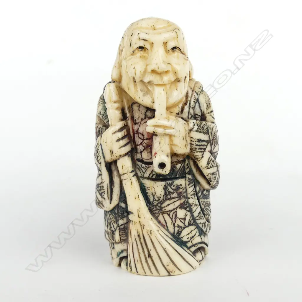 A Japanese carved bone netsuke of an old woman Image 1++