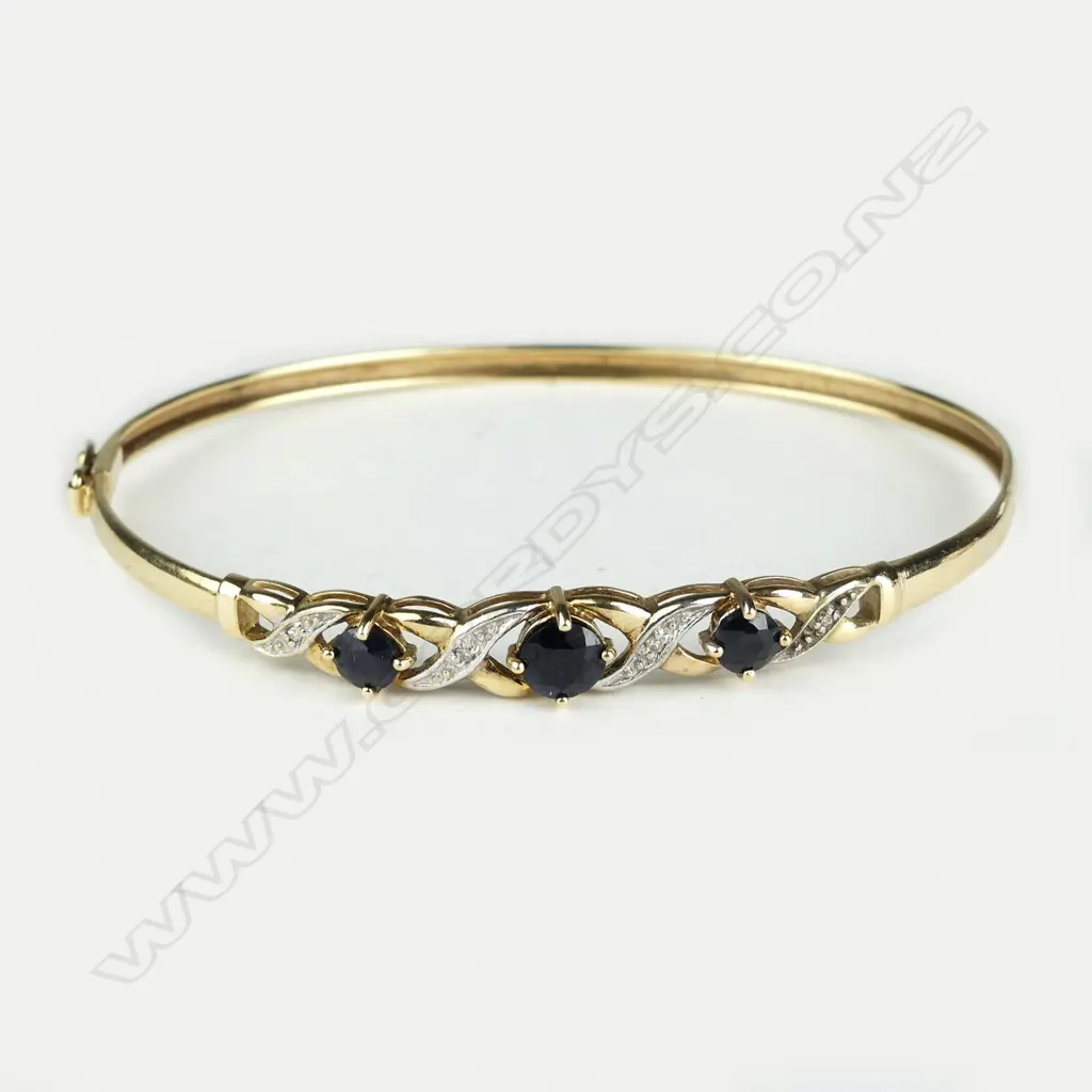 An early/mid-20thC 9ct. yellow gold sapphire and diamond hinged bangle Image 1++