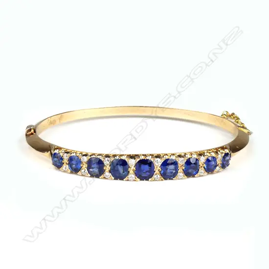 A Victorian 9ct rose gold sapphire and diamond hinged bangle