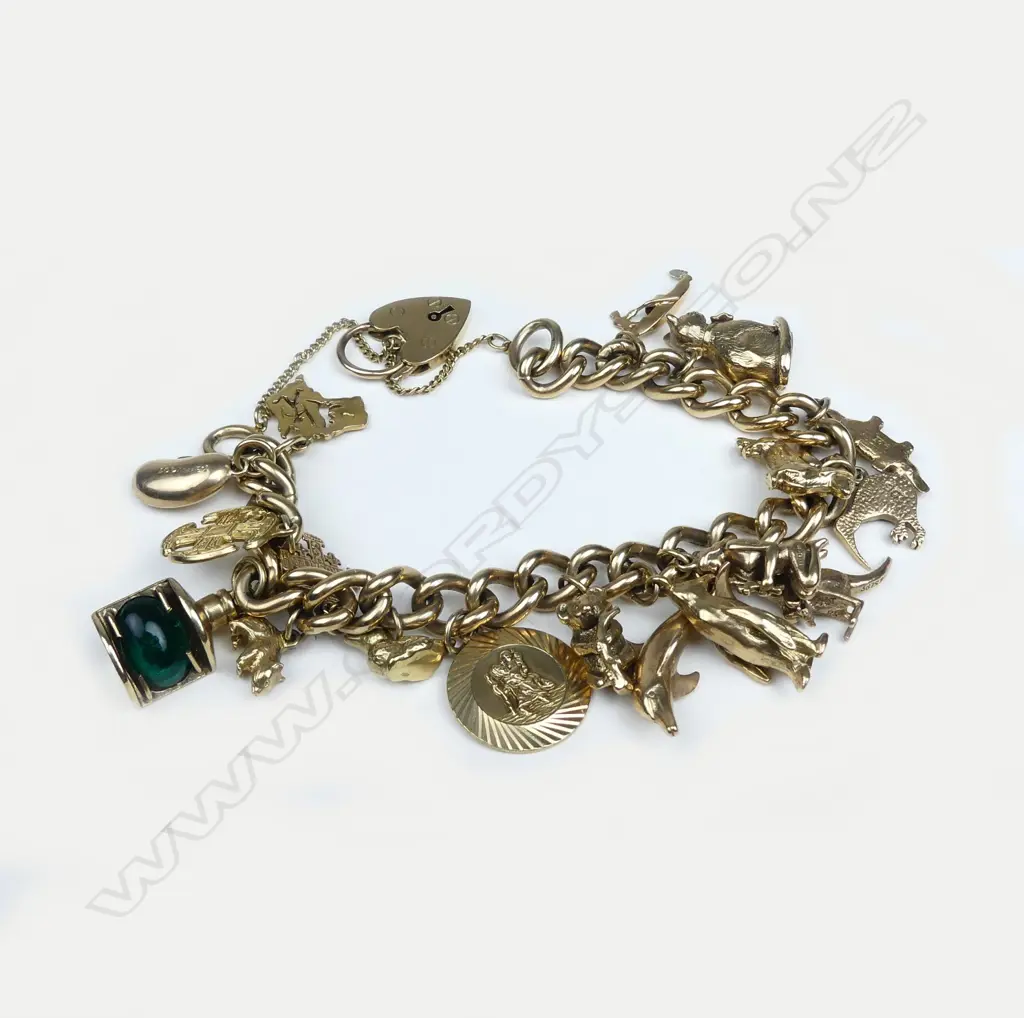 A 9ct gold curb link charm bracelet Image 1++