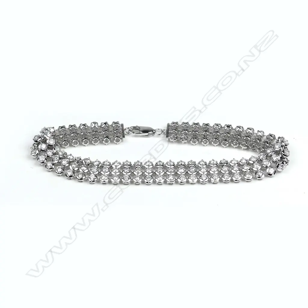 A modern 18ct. white gold and diamond triple band tennis type bracelet Image 1++