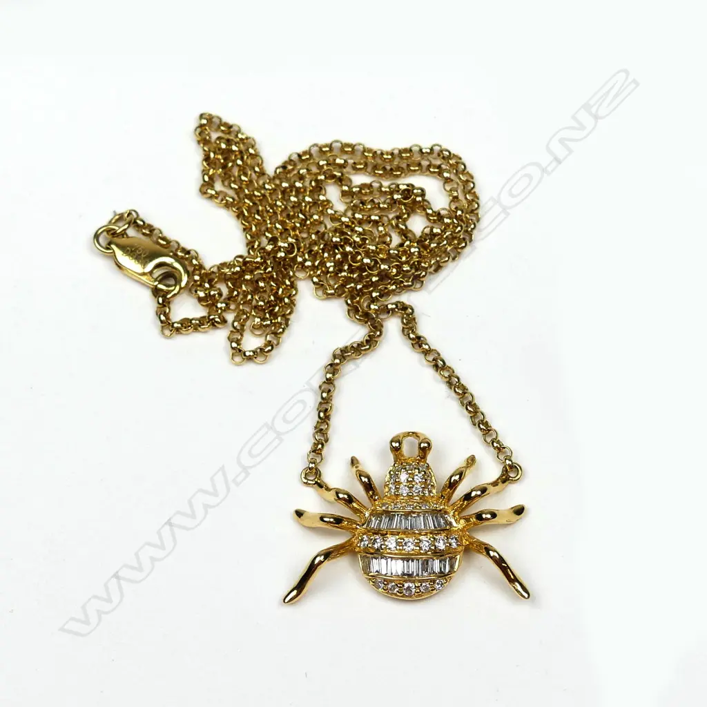 An 18ct. yellow gold and diamond set spider pendant on chain Image 1++