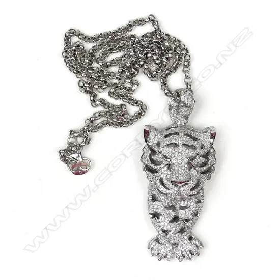 A modern 18ct. white gold and diamond designer tiger pendant on an 18ct. white gold chain