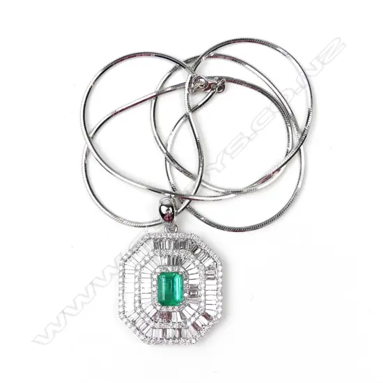 A striking 18ct white gold emerald and diamond pendant on chain