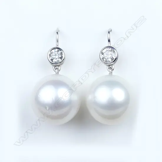 A pair of 14ct white gold pearl and diamond drop earrings