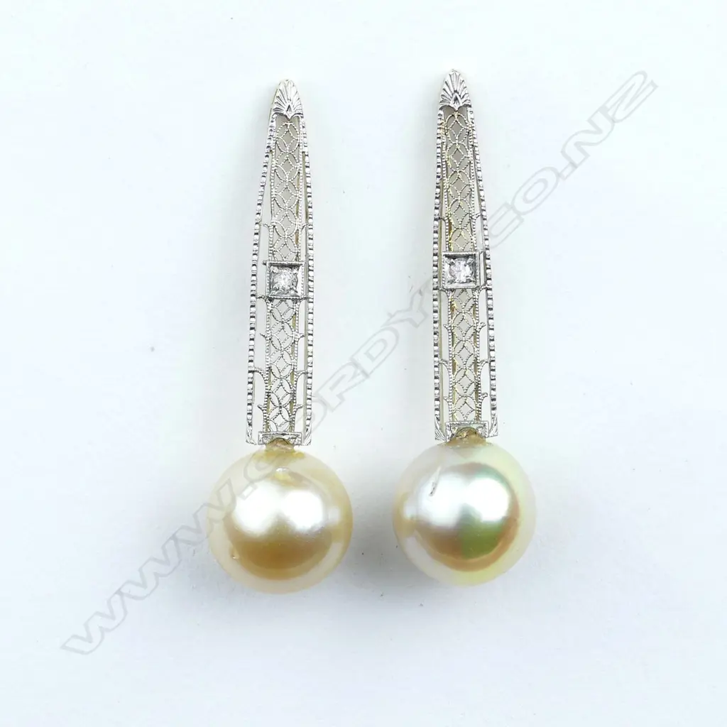A pair of 14ct gold pearl and diamond drop earrings Image 1++