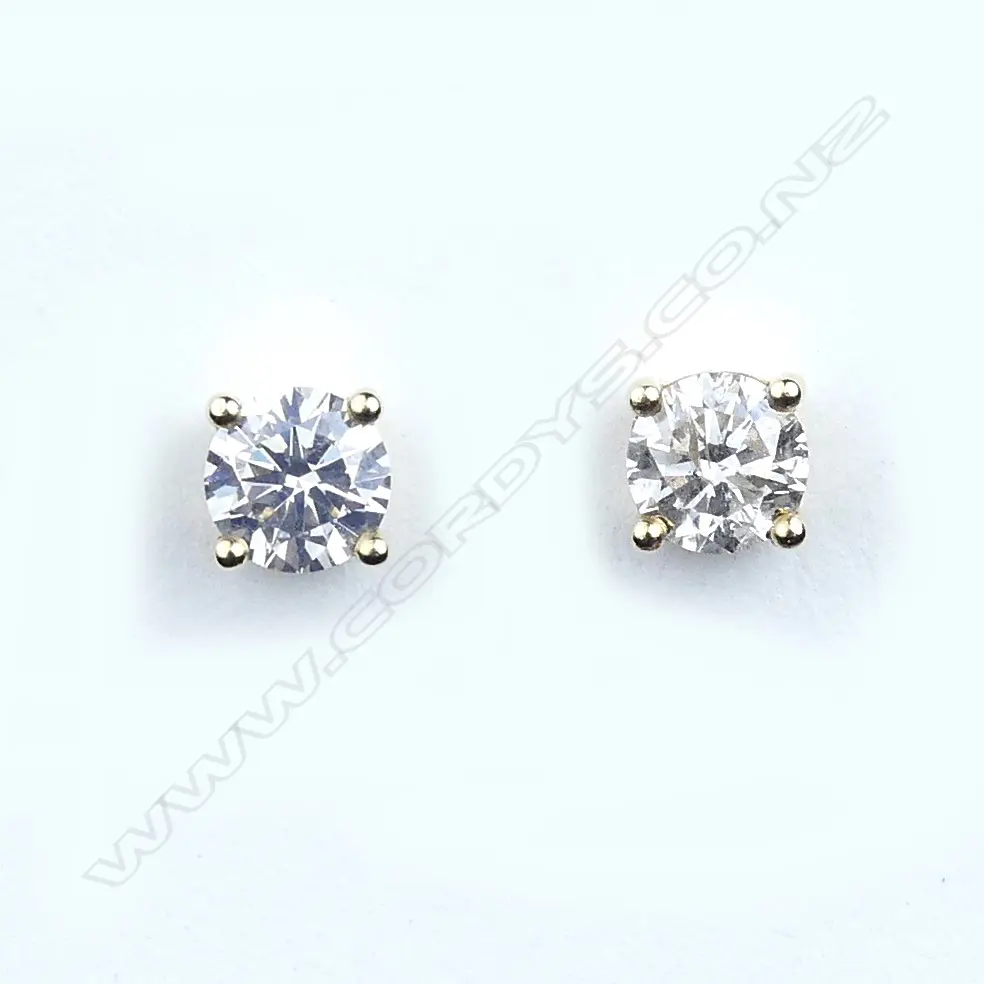 A pair of 14ct gold and diamond stud earrings Image 1++