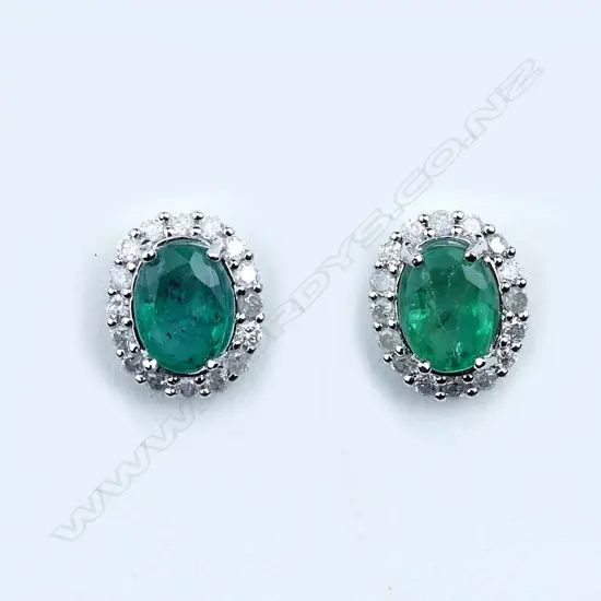 A pair of 14ct white gold emerald and diamond earrings