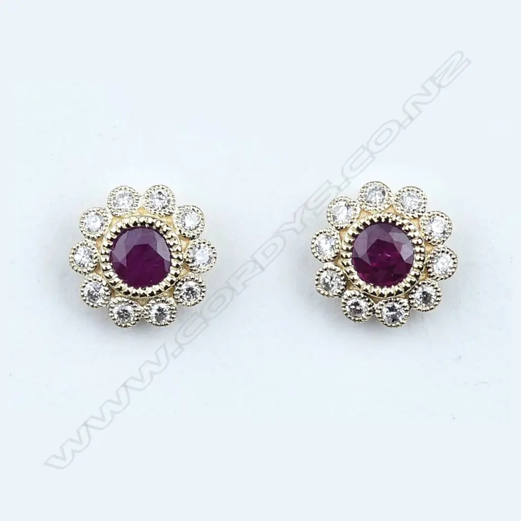 A pair of 14ct gold ruby and diamond stud earrings Image 1++