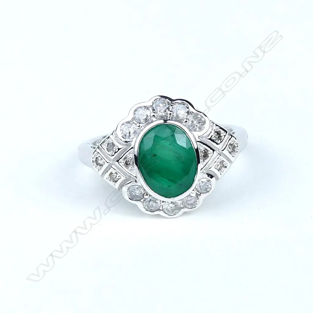 An 18ct white gold emerald and diamond ring Image 1++
