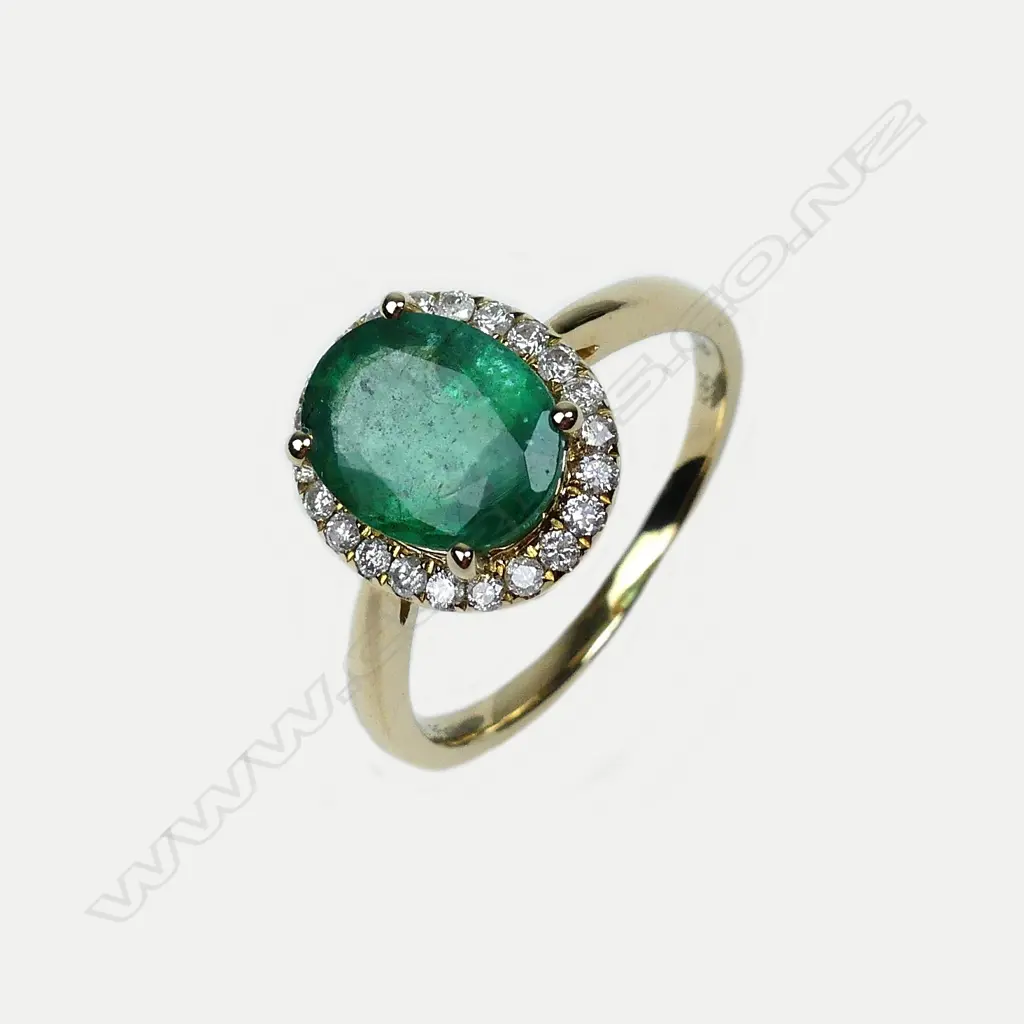 A 14ct gold emerald and diamond ring Image 1++