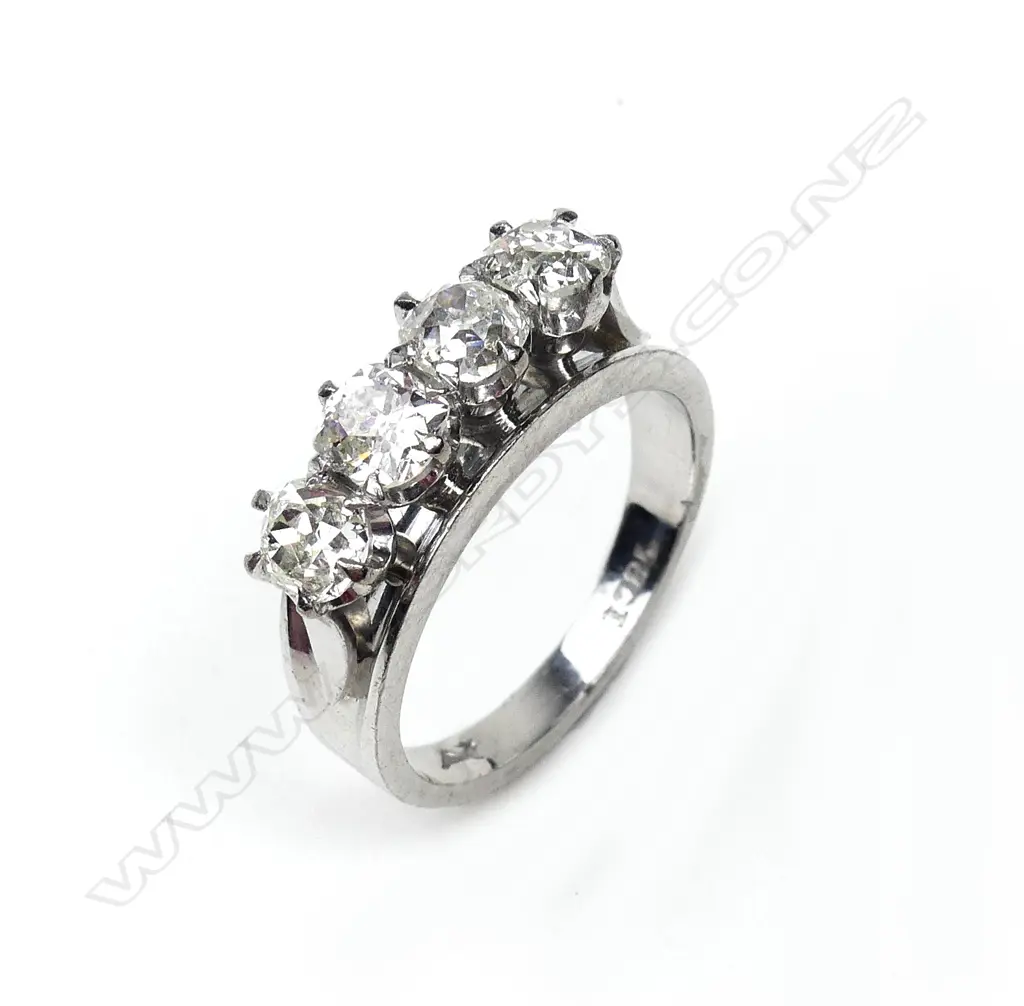 An 18ct white gold and four stone diamond ring Image 1++