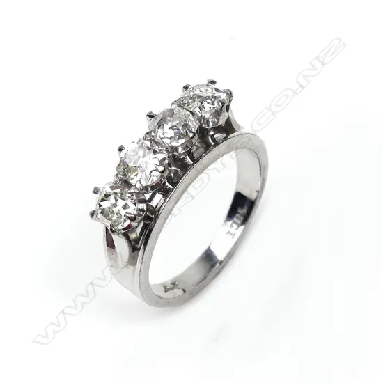 An 18ct white gold and four stone diamond ring