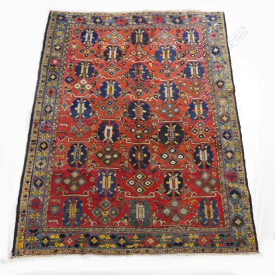 An antique hand knotted Caucasian rug