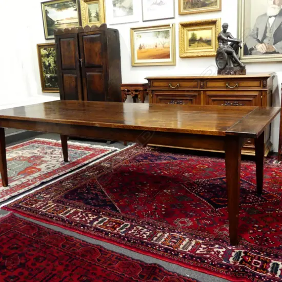 An oak French provincial style dining table