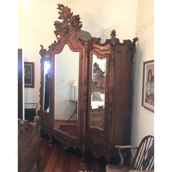 A rare and special 19thC Venetian rococo large three section mirrored door armoire with high relief and ornate scroll