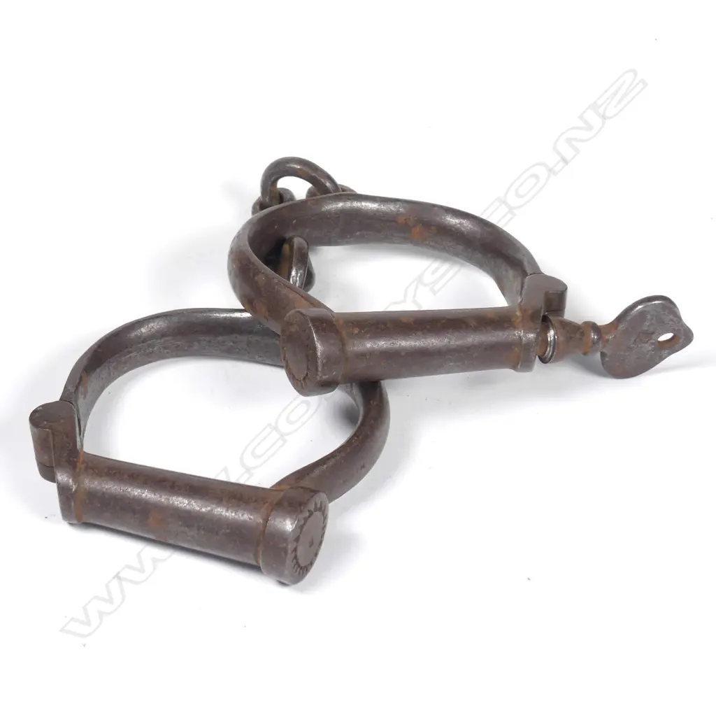 An early 20thC pair of wrought iron handcuffs Image 1++