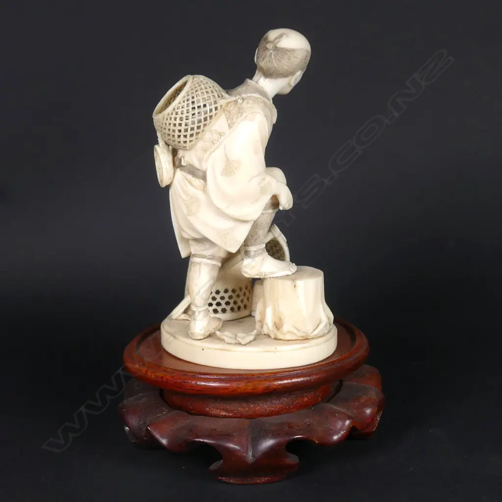 A Japanese Meiji period ivory okimono of a basket seller Image 1++