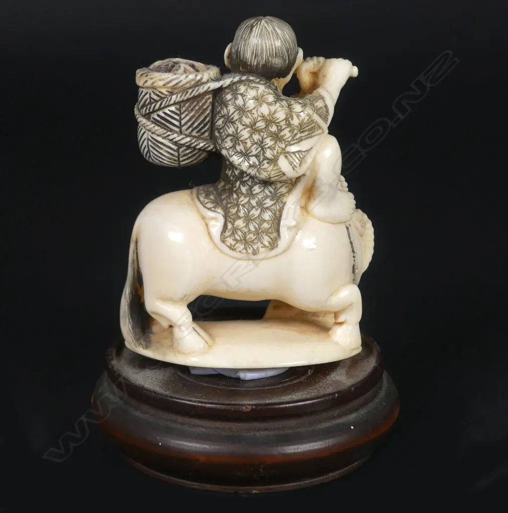 A Japanese small ivory okimono of a boy riding the bull home Image 1++