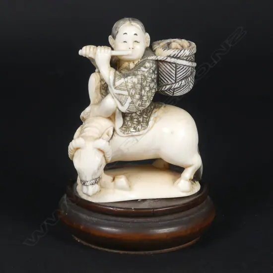 A Japanese small ivory okimono of a boy riding the bull home