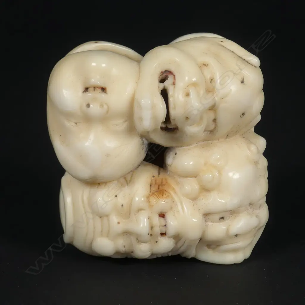 A Japanese marine ivory netsuke of a group of five masks Image 1++