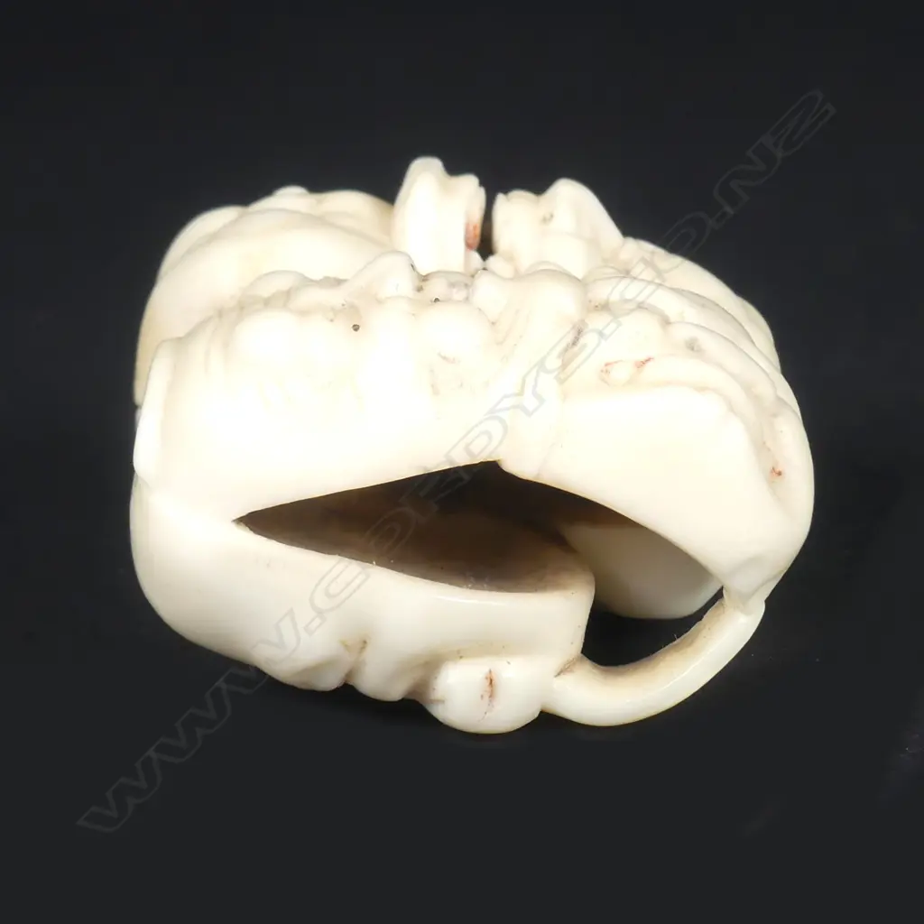 A Japanese marine ivory netsuke of a group of five masks Image 1++