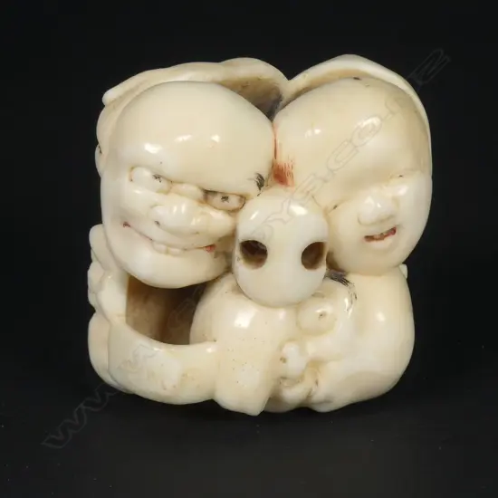 A Japanese marine ivory netsuke of a group of five masks