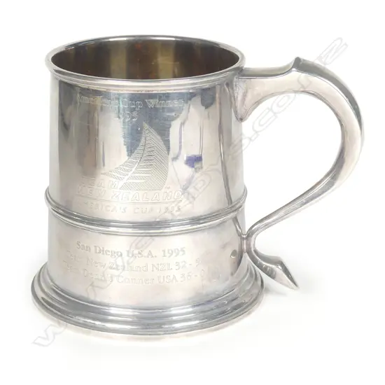 A silver America's Cup 1995 winner’s trophy mug