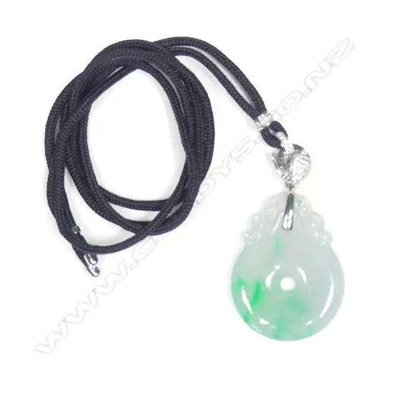 A modern 18ct. white gold and diamond supported carved jadeite pendant