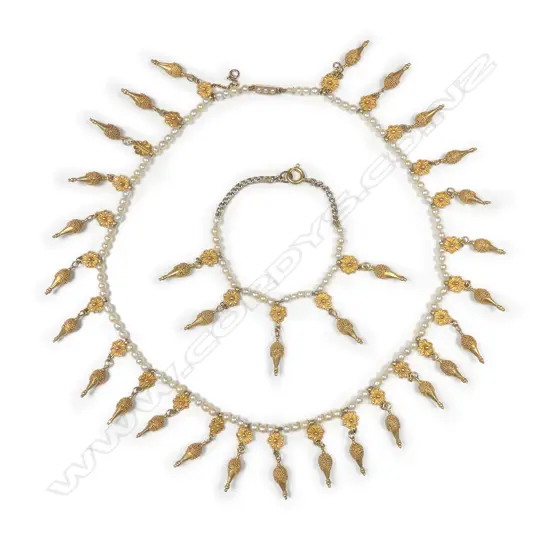 A delicate pearl and gold necklace in the Etruscan Revival style