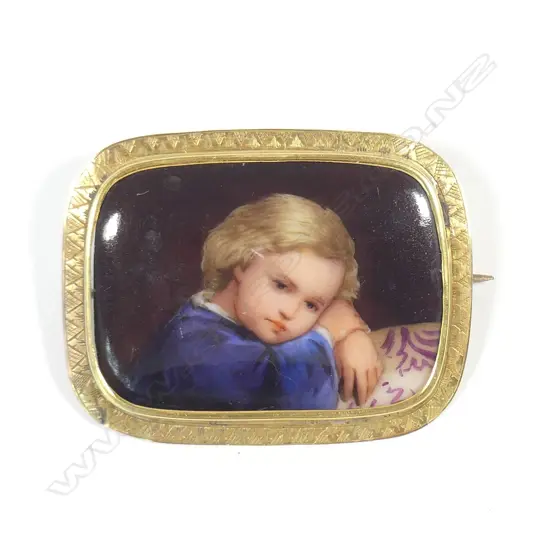 A 19thC 14ct. yellow gold framed hand painted porcelain brooch