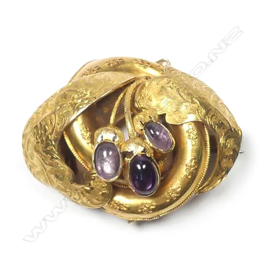 A large Victorian gilded gold and amethyst brooch