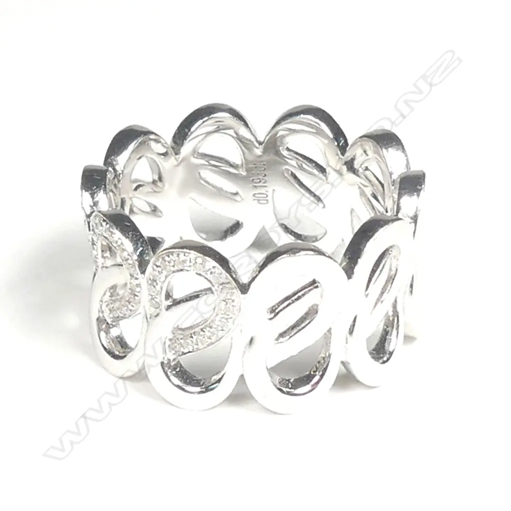 An 18ct. white gold and diamond set lover's knot eternity band Image 1++